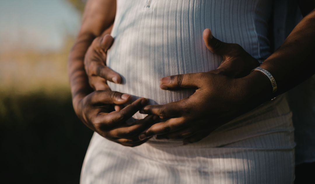 Pregnant Belly with Couples Hands on Her Belly