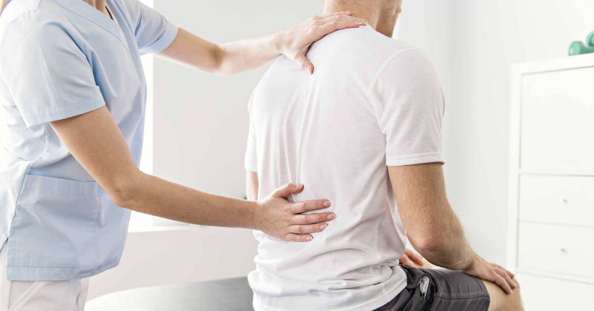 Photo of a chiropractor doing manual therapy on a client's back