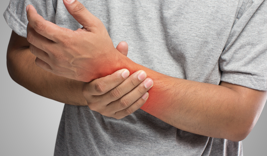 Photo of a man holding his inflamed sprained left wrist